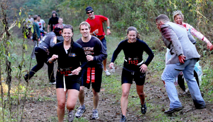 two people through leaves in the air and having fun in fall
